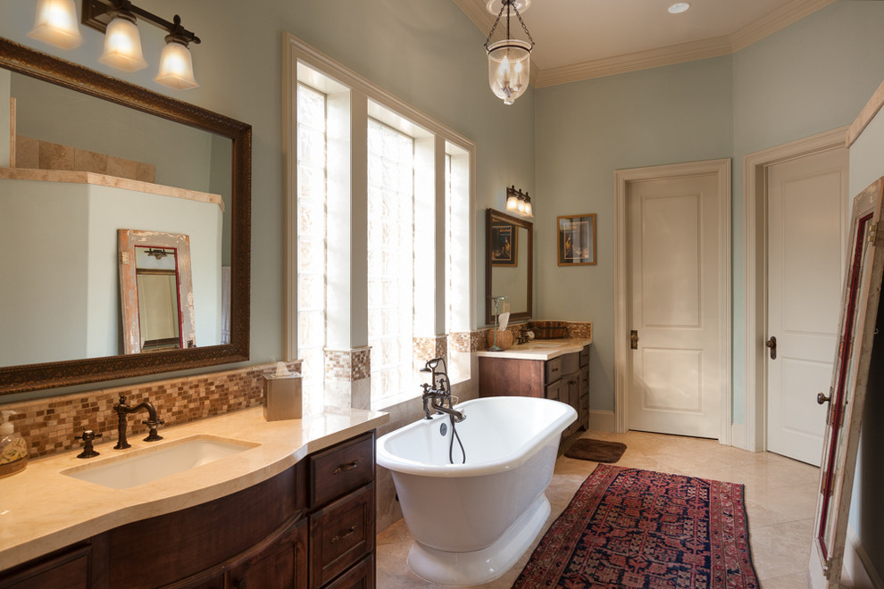 Freestanding bathtub - mid-sized rustic master beige tile and ceramic tile marble floor freestanding bathtub idea with furniture-like cabinets, medium tone wood cabinets, soapstone countertops and blue walls