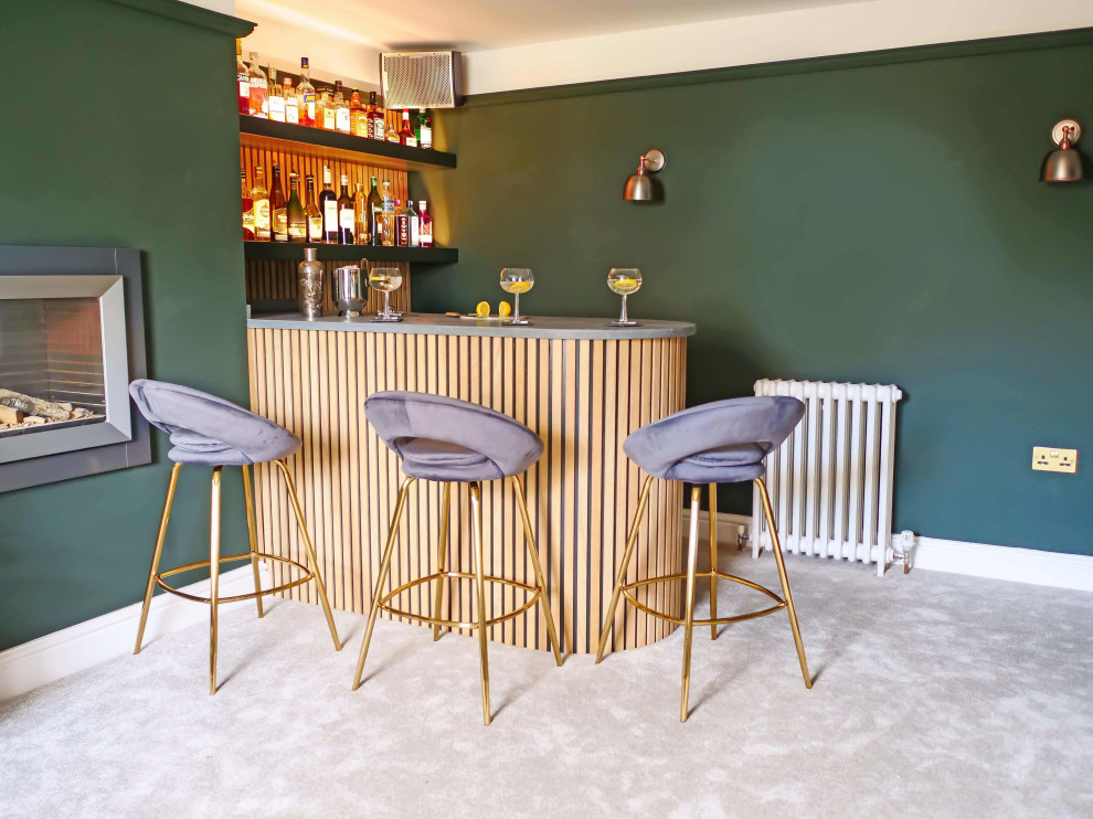 Photo of a small contemporary home bar in Hampshire with no sink, open cabinets, light wood cabinets, quartzite benchtops, carpet, grey floor and grey benchtop.