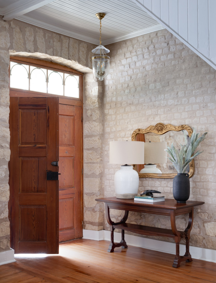 Ejemplo de distribuidor clásico con paredes beige, suelo de madera en tonos medios, puerta doble, puerta de madera en tonos medios y suelo marrón