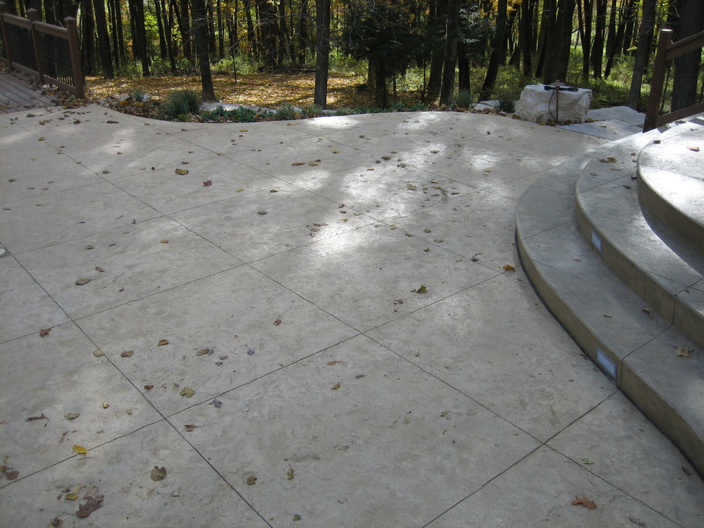 Example of a large transitional backyard concrete paver and rectangular natural pool house design in Cedar Rapids
