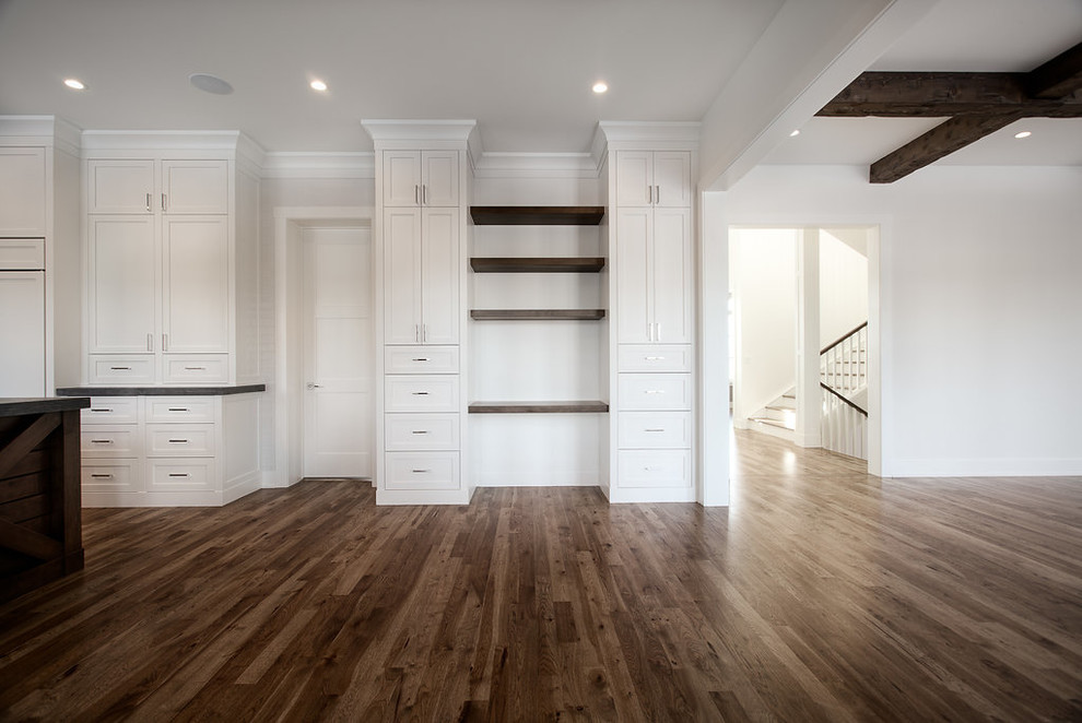 Inspiration for a large transitional u-shaped eat-in kitchen remodel in Calgary with shaker cabinets, paneled appliances and an island