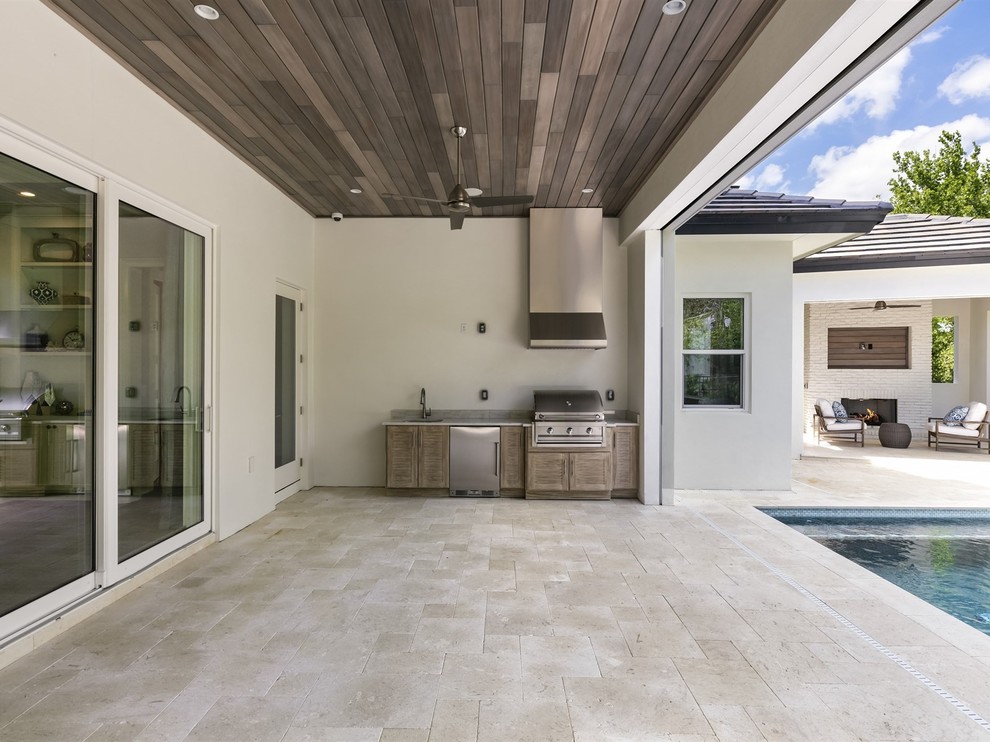 Example of a mid-sized transitional backyard stone patio design in Orlando with a fire pit and a gazebo