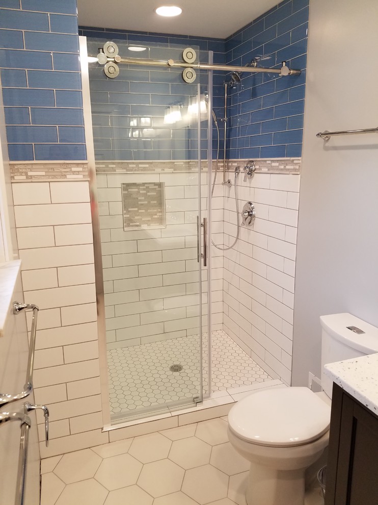Example of a small transitional 3/4 blue tile and glass tile porcelain tile alcove shower design in Cincinnati with recessed-panel cabinets, black cabinets, a two-piece toilet, gray walls, an undermount sink and quartz countertops