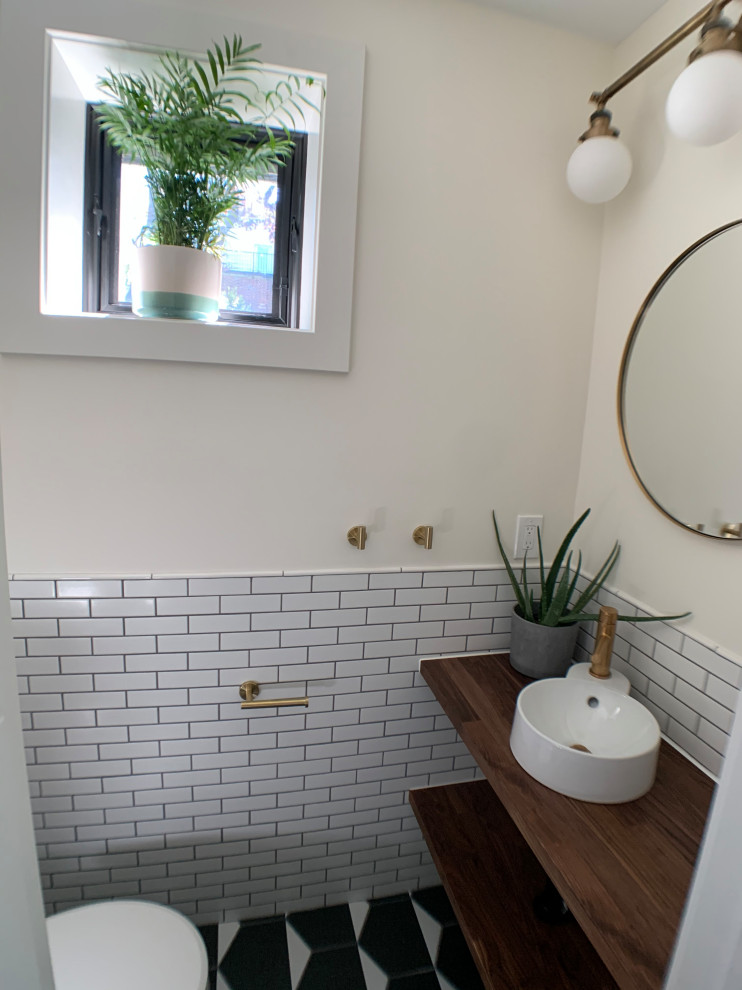 Inspiration for a mid-sized modern kids bathroom in DC Metro with open cabinets, dark wood cabinets, a shower/bathtub combo, white tile, white walls, laminate floors, a wall-mount sink, wood benchtops, brown floor, a shower curtain, a single vanity and a freestanding vanity.