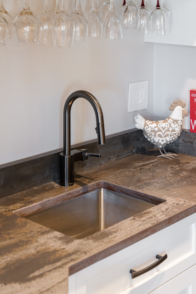Large transitional medium tone wood floor and brown floor open concept kitchen photo with a double-bowl sink, flat-panel cabinets, white cabinets, quartz countertops, stainless steel appliances, an island and brown countertops
