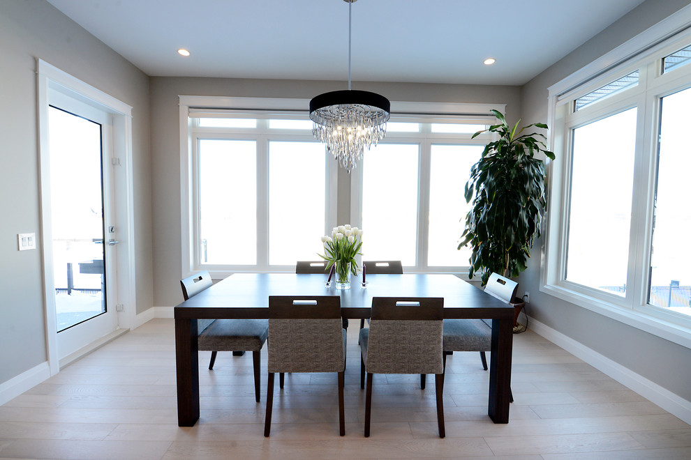 Inspiration for a mid-sized contemporary open plan dining in Edmonton with grey walls and light hardwood floors.