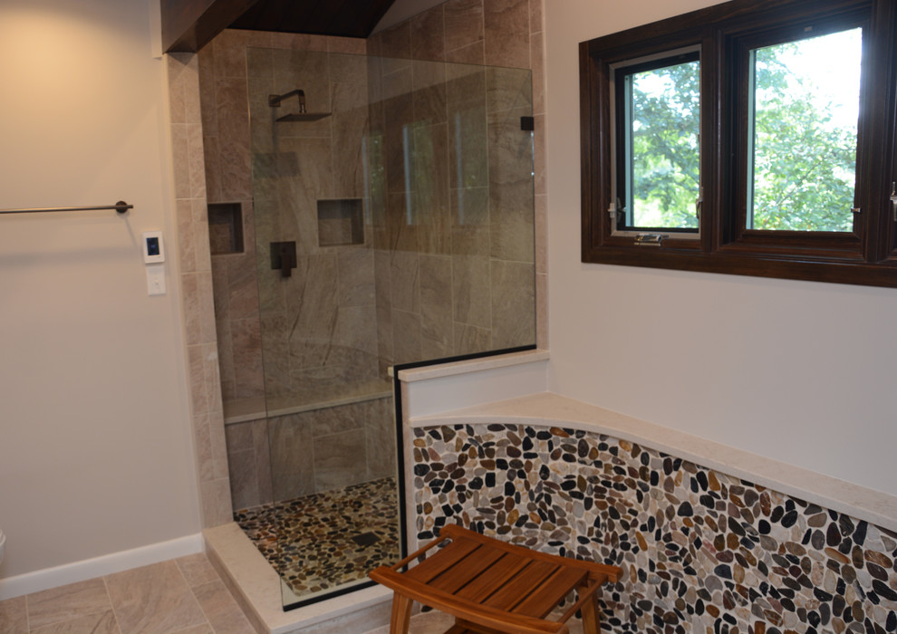 This is an example of a mid-sized transitional master bathroom in DC Metro with recessed-panel cabinets, beige cabinets, a corner shower, a two-piece toilet, beige tile, grey walls, an undermount sink, engineered quartz benchtops, beige floor, an open shower and beige benchtops.