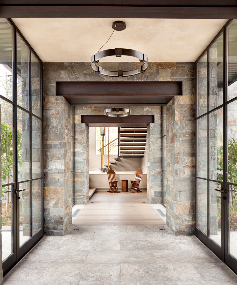 Contemporary entry hall in Denver with a glass front door.