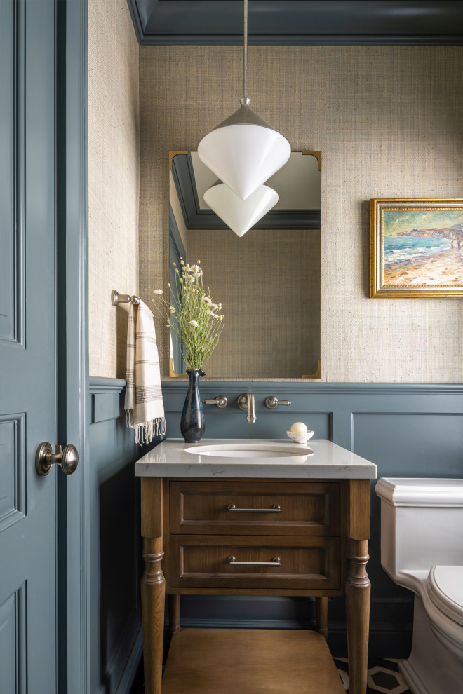 Powder room - traditional wainscoting powder room idea in San Francisco with blue walls, a console sink, quartzite countertops and white countertops