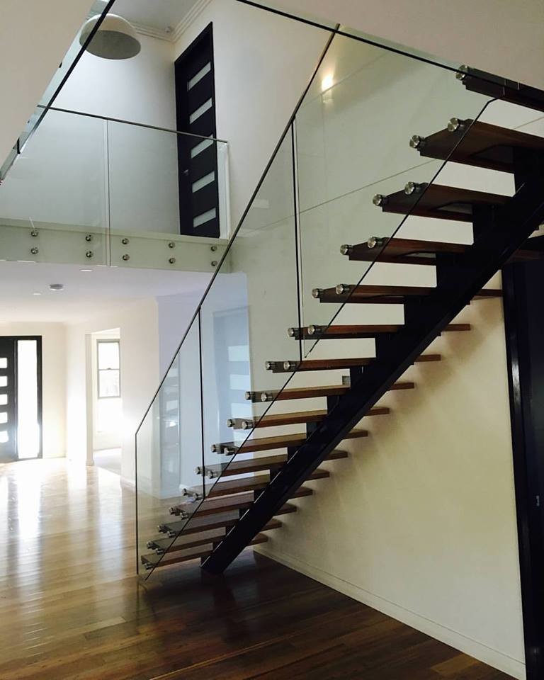 This is an example of a contemporary wood straight staircase in Sydney with open risers.