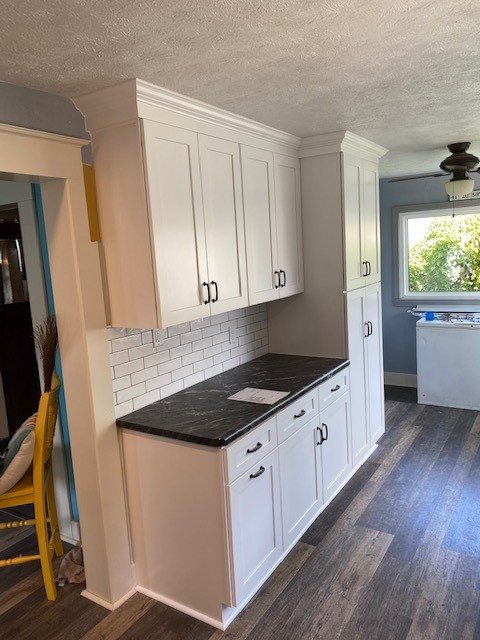 Example of a small transitional l-shaped eat-in kitchen design with a single-bowl sink, white cabinets, laminate countertops, white backsplash and ceramic backsplash