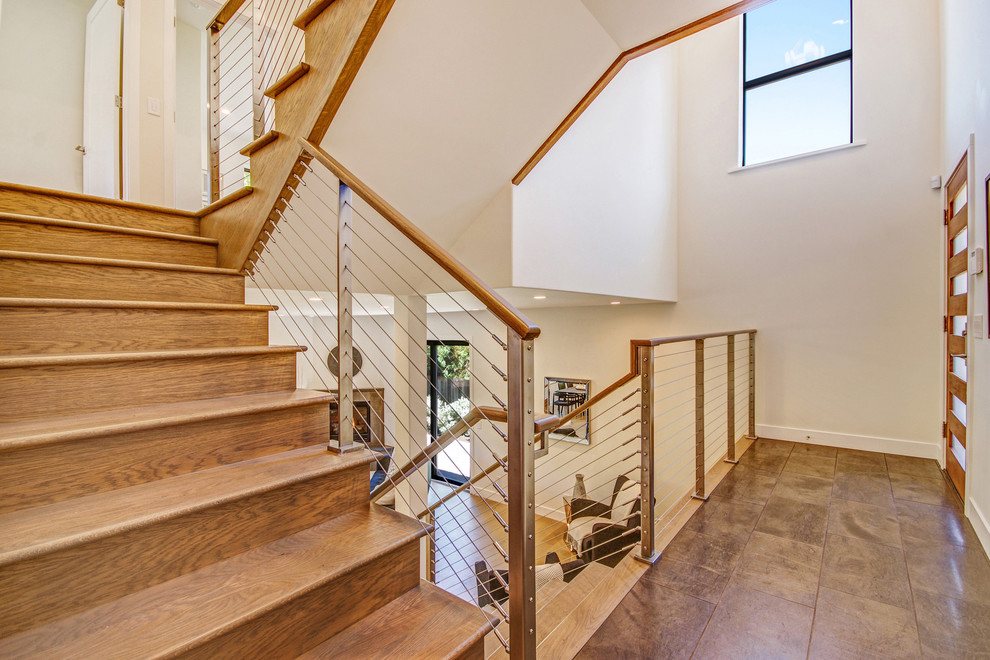 Photo of a large transitional wood l-shaped staircase in San Francisco with wood risers.
