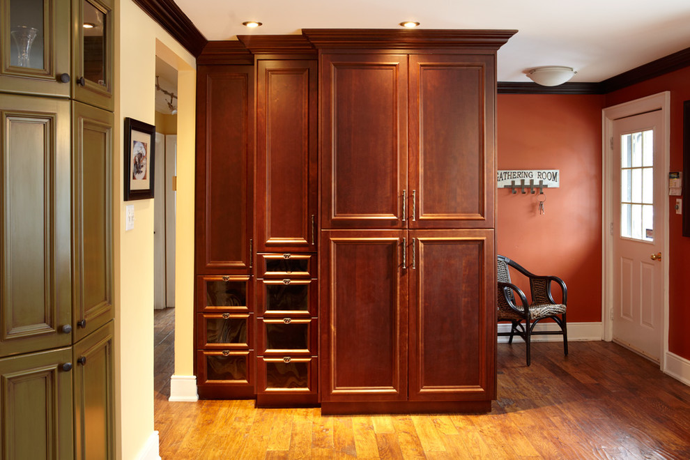 Inspiration for a mid-sized transitional light wood floor kitchen remodel in Toronto with dark wood cabinets