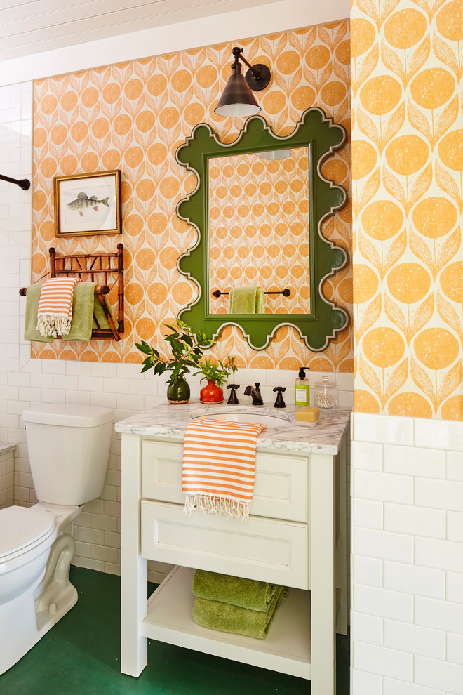 This is an example of a beach style bathroom in Other with white cabinets, white tile, subway tile, orange walls, an undermount sink, green floor, white benchtops and recessed-panel cabinets.