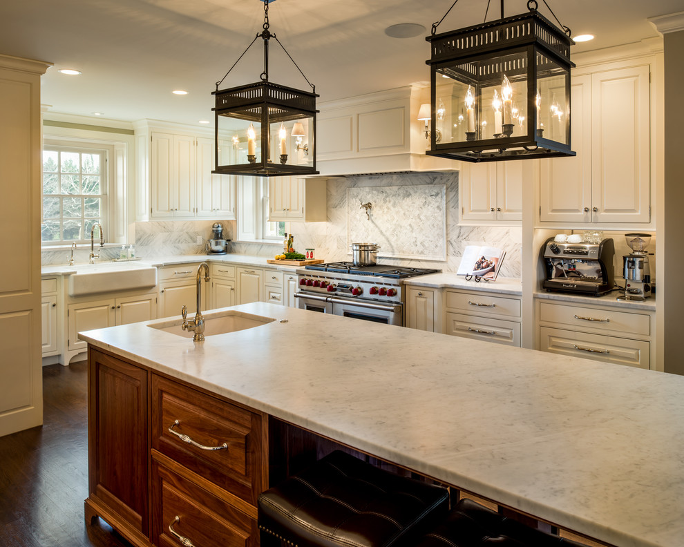 Design ideas for a large traditional u-shaped open plan kitchen in Philadelphia with a farmhouse sink, raised-panel cabinets, marble benchtops, white splashback, stainless steel appliances, with island, stone tile splashback, dark hardwood floors and white cabinets.