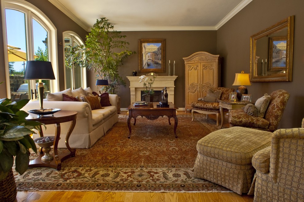 Photo of a traditional enclosed living room in San Francisco with brown walls and a standard fireplace.