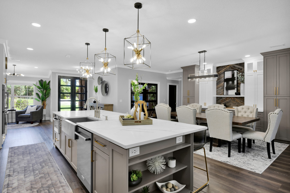 Large country single-wall eat-in kitchen in Jacksonville with a farmhouse sink, recessed-panel cabinets, white cabinets, quartz benchtops, black splashback, mosaic tile splashback, stainless steel appliances, vinyl floors, with island, brown floor and white benchtop.