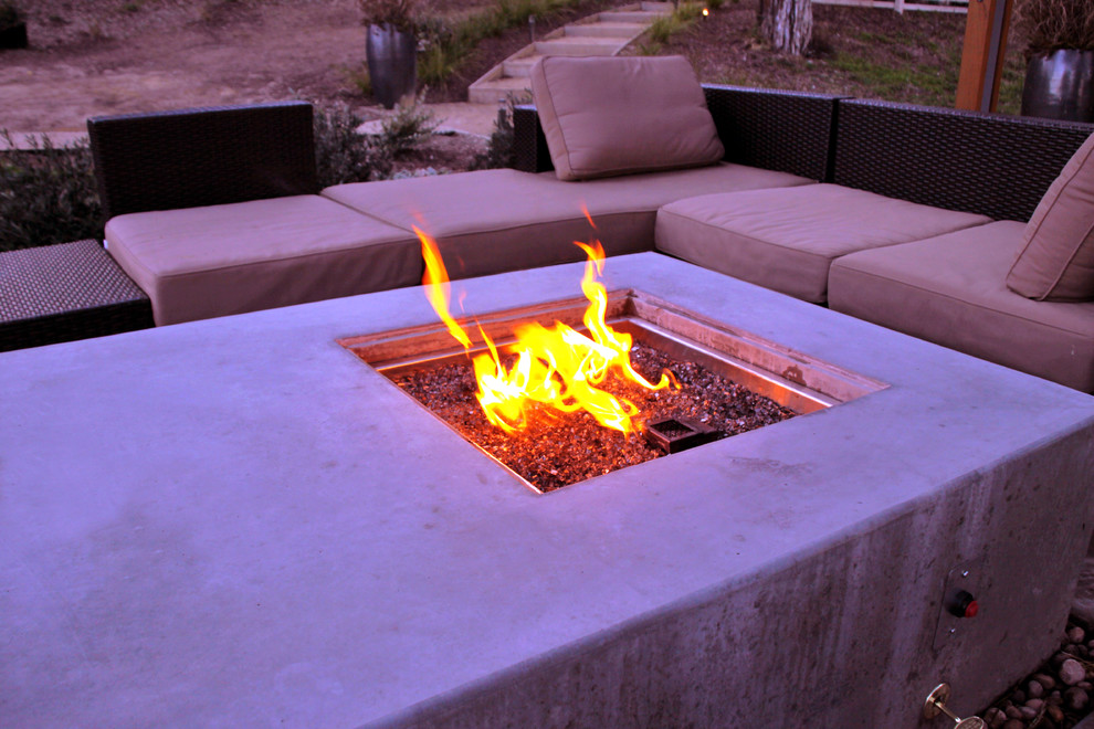 Inspiration for a mid-sized modern backyard patio in San Francisco with a fire feature, concrete slab and a pergola.