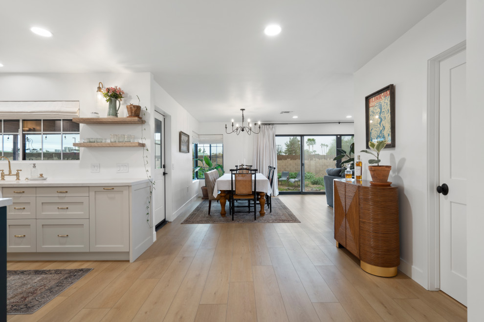 Photo of a medium sized farmhouse open plan dining room in Phoenix with white walls, vinyl flooring and beige floors.