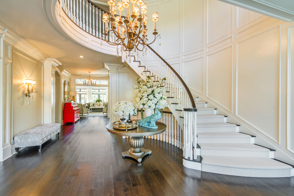 Photo of a large traditional foyer in New York with white walls, a double front door, dark hardwood floors and brown floor.