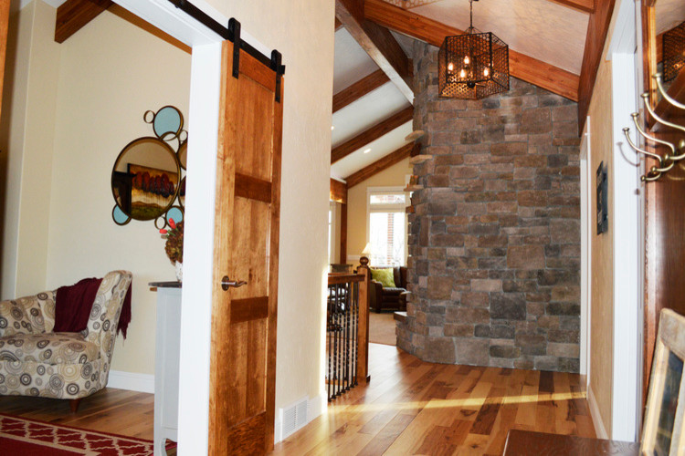 Example of a mountain style medium tone wood floor hallway design with beige walls