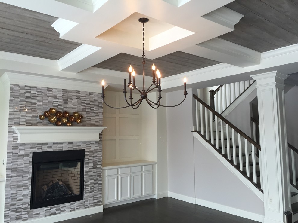 Inspiration for a mid-sized transitional open concept dark wood floor and brown floor family room remodel in Cincinnati with a tile fireplace, no tv, a standard fireplace and gray walls