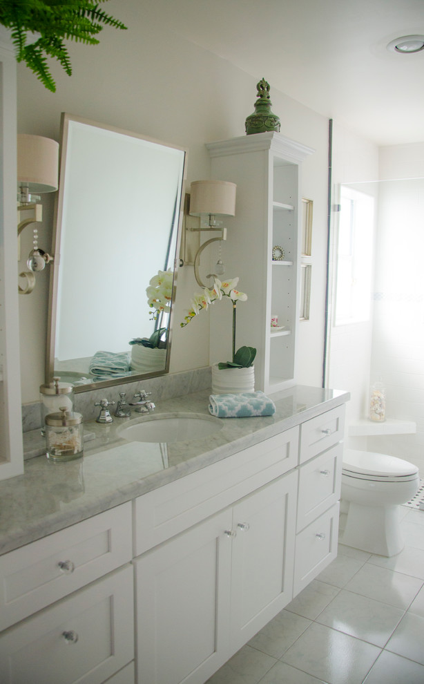 This is an example of a traditional bathroom in Miami with grey walls and porcelain floors.