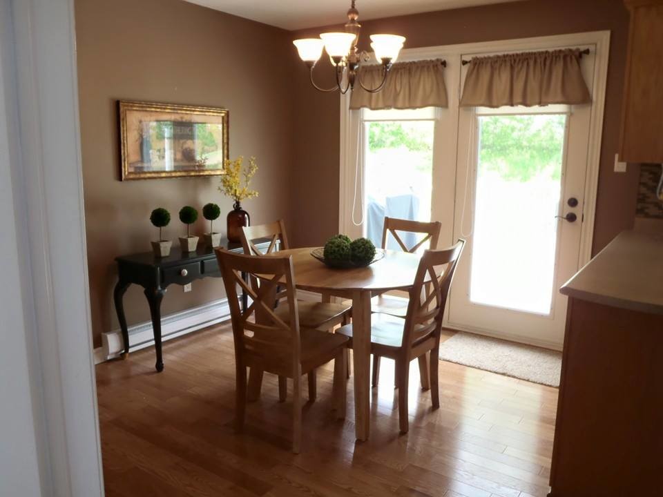 Small transitional light wood floor kitchen/dining room combo photo with brown walls and no fireplace