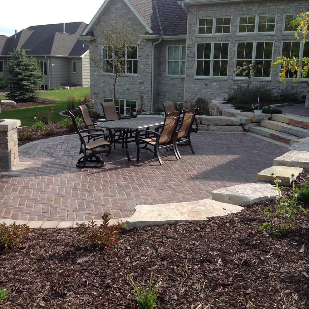 Patio - large rustic backyard shade patio idea