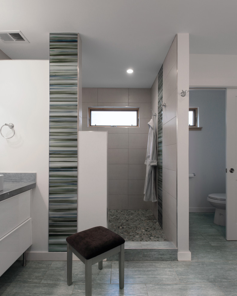 Design ideas for a mid-sized contemporary master bathroom in DC Metro with an undermount sink, flat-panel cabinets, white cabinets, engineered quartz benchtops, an alcove shower, a two-piece toilet, gray tile, pebble tile, white walls and porcelain floors.