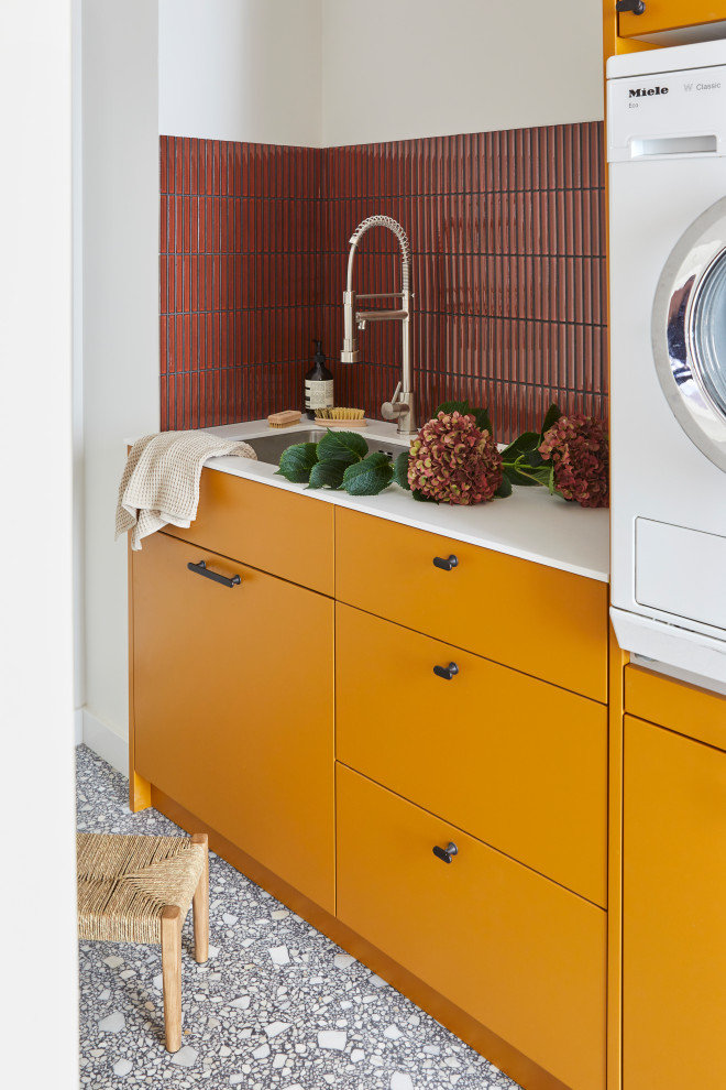 Photo of a small contemporary laundry room in London.