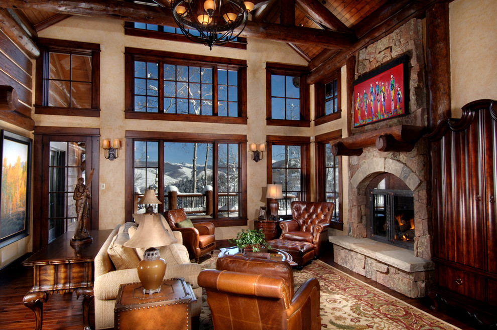 Large country formal open concept living room in Denver with beige walls, dark hardwood floors, a standard fireplace, a stone fireplace surround, no tv and brown floor.