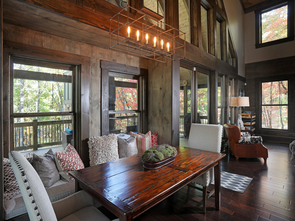 Inspiration for a mid-sized arts and crafts open plan dining in Atlanta with grey walls, dark hardwood floors, a standard fireplace and a wood fireplace surround.