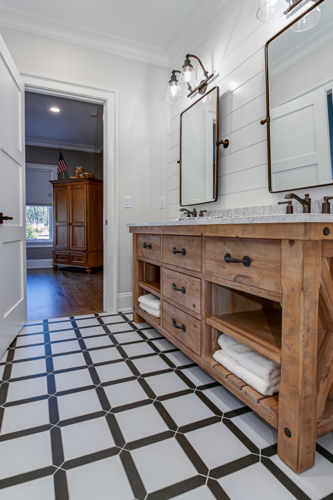 Photo of a country master bathroom in Other with flat-panel cabinets, medium wood cabinets, white walls, an undermount sink, multi-coloured floor and grey benchtops.