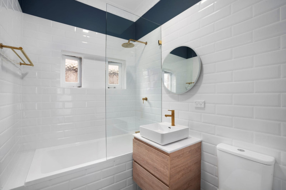 Example of a small 1960s 3/4 white tile and porcelain tile porcelain tile, gray floor and single-sink bathroom design in Sydney with furniture-like cabinets, medium tone wood cabinets, a one-piece toilet, blue walls, a vessel sink, quartz countertops, white countertops and a floating vanity
