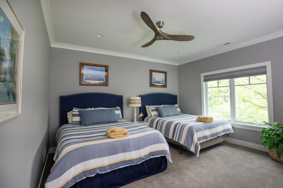 Example of a large beach style guest carpeted and gray floor bedroom design in Milwaukee with gray walls
