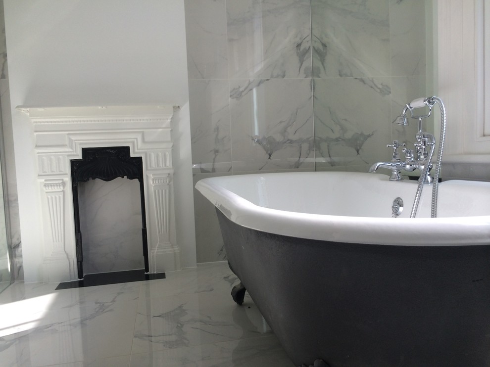 Mid-sized contemporary master bathroom in London with a console sink, a claw-foot tub, a curbless shower, a two-piece toilet, white tile, porcelain tile, white walls and porcelain floors.