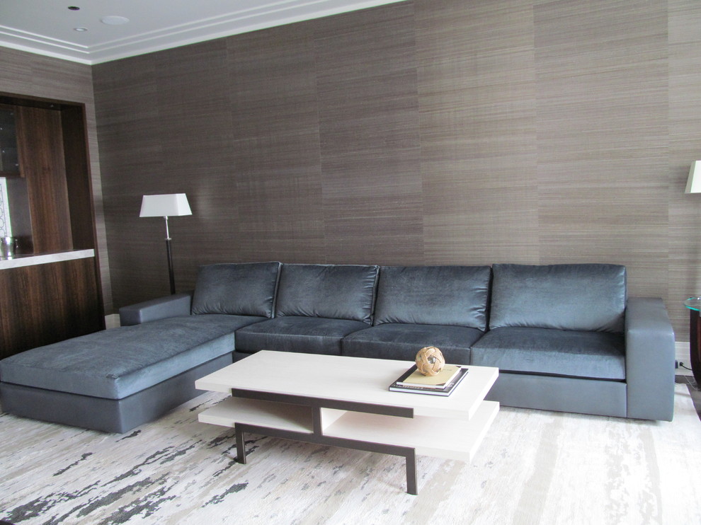 This is an example of a large contemporary formal enclosed living room in Chicago with brown walls, dark hardwood floors, no fireplace, no tv and brown floor.