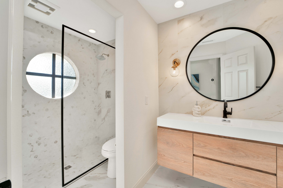 Photo of a contemporary 3/4 bathroom in San Francisco with flat-panel cabinets, medium wood cabinets, a curbless shower, beige tile, white walls, an integrated sink, engineered quartz benchtops, multi-coloured floor, an open shower, white benchtops, a single vanity and a floating vanity.