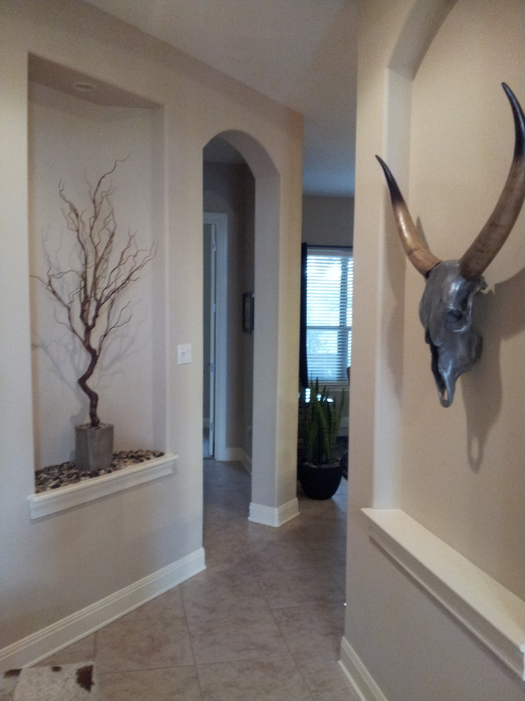 Example of a mid-sized mountain style porcelain tile and beige floor hallway design in Austin with beige walls