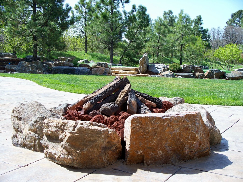 Design ideas for a mid-sized country backyard full sun garden in Denver with a fire feature and concrete pavers.