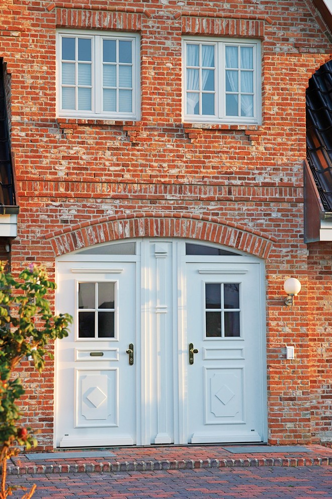 Inspiration for a traditional front door with a double front door and a white front door.