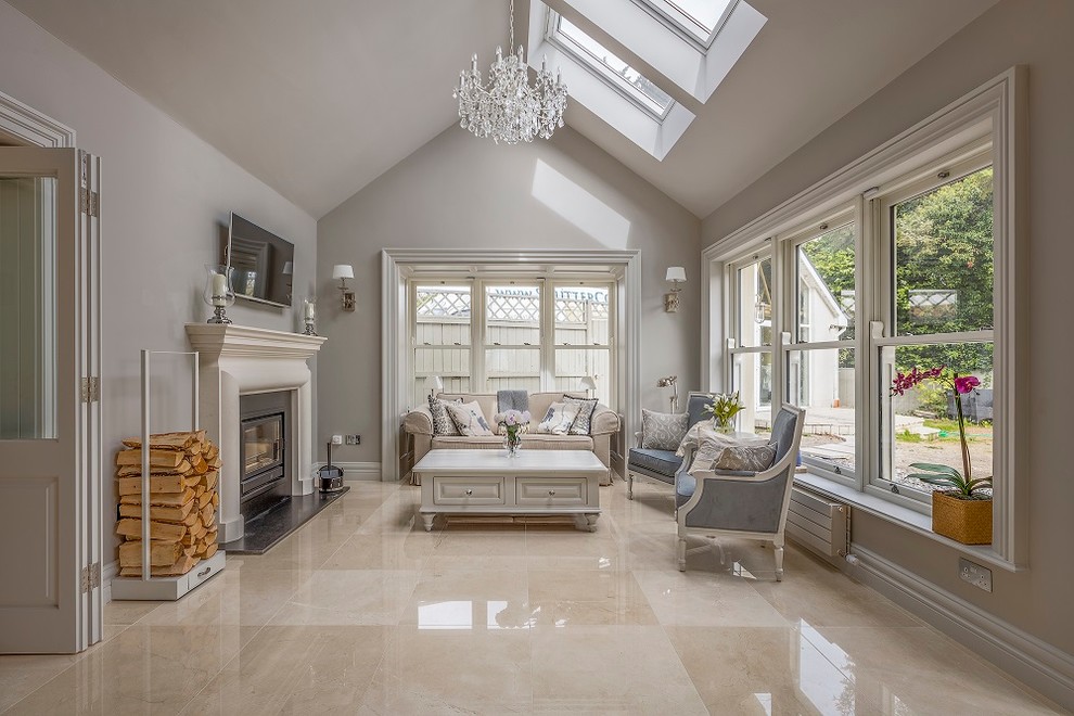 Photo of a large traditional living room in Dublin with grey walls, marble floors and a wall-mounted tv.