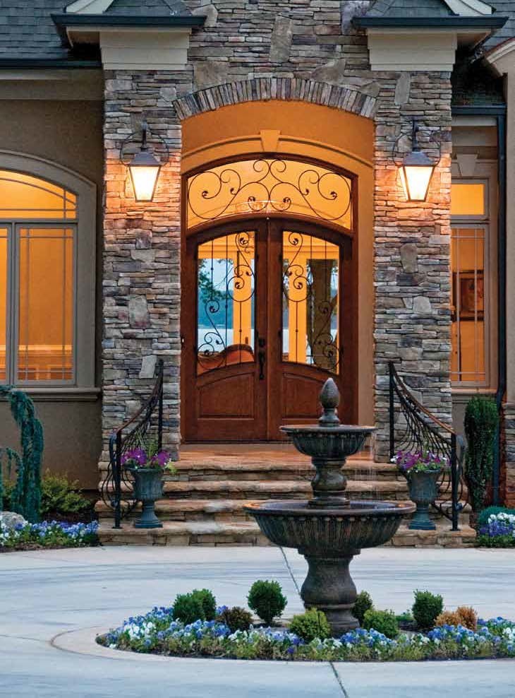 Inspiration for a large front door in Tampa with a double front door and a medium wood front door.
