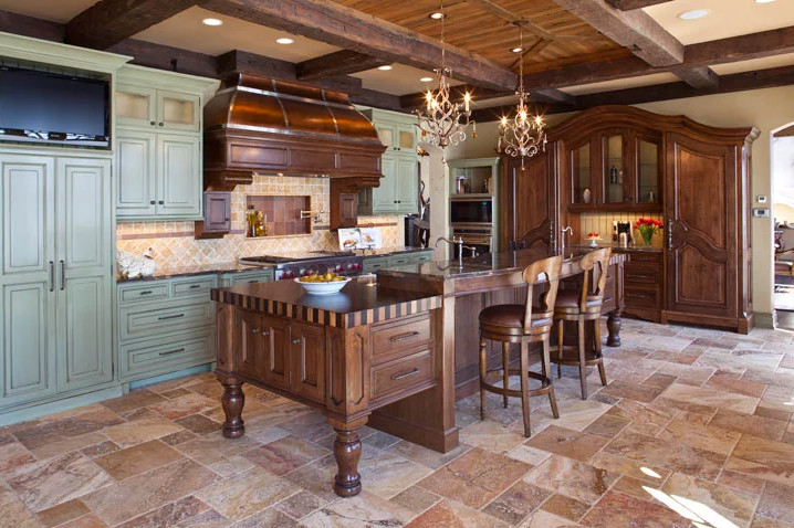 Enclosed kitchen - mid-sized transitional l-shaped travertine floor enclosed kitchen idea in New York with raised-panel cabinets, green cabinets, onyx countertops, beige backsplash, stone tile backsplash, stainless steel appliances and an island