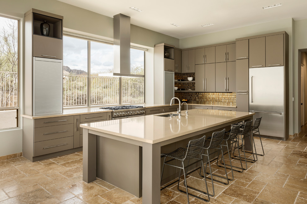 Photo of a large contemporary l-shaped kitchen in Phoenix with an undermount sink, grey cabinets, quartz benchtops, metallic splashback, glass tile splashback, stainless steel appliances, travertine floors, with island, beige floor and flat-panel cabinets.