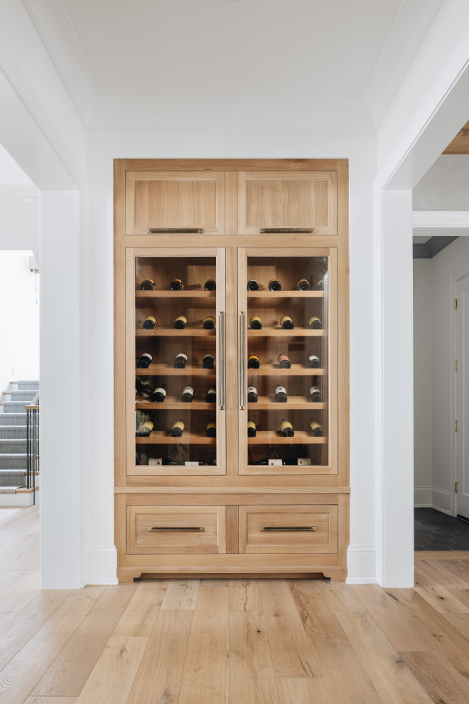 Large transitional wine cellar in Chicago with light hardwood floors and brown floor.
