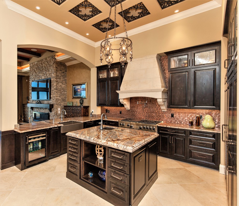 Photo of a mediterranean u-shaped kitchen in Orlando with a farmhouse sink, raised-panel cabinets, black cabinets, metallic splashback, metal splashback, panelled appliances, with island, beige floor and multi-coloured benchtop.