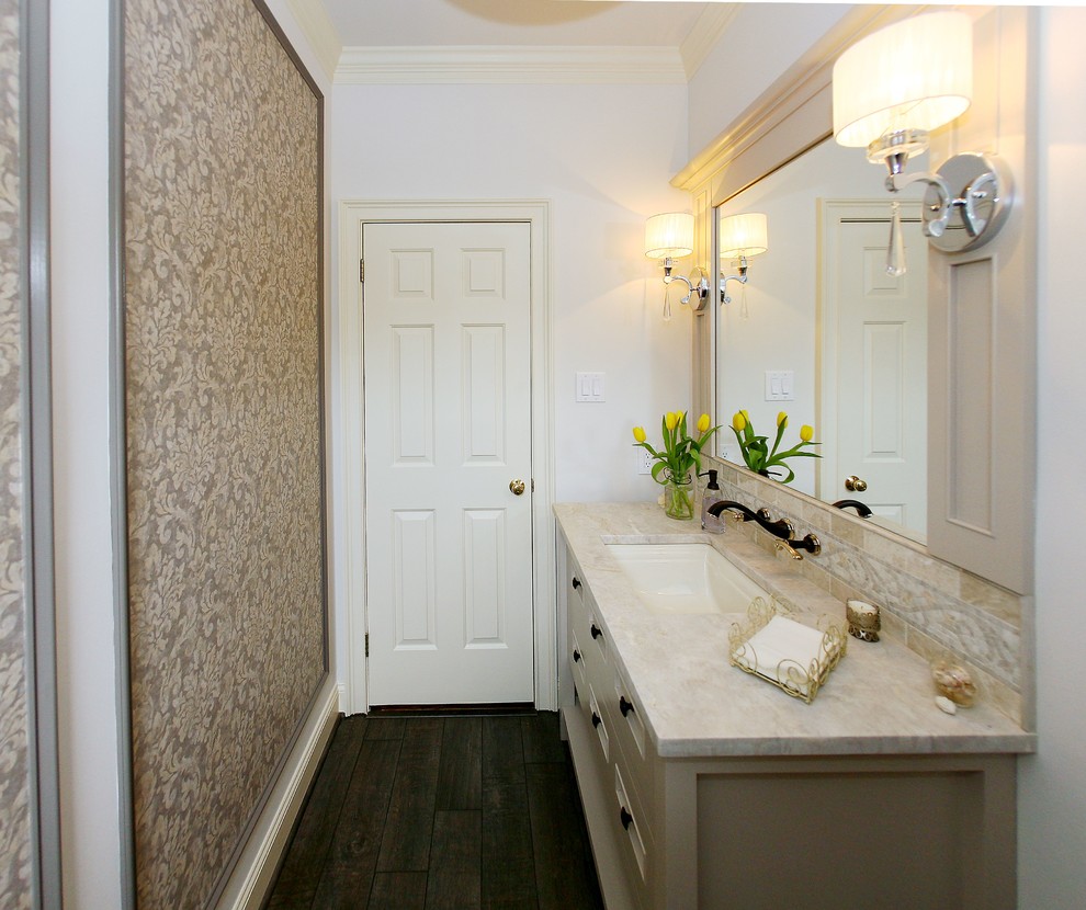 Inspiration for a mid-sized transitional powder room in Philadelphia with furniture-like cabinets, white cabinets, a two-piece toilet, beige walls, plywood floors, an undermount sink, marble benchtops and beige benchtops.