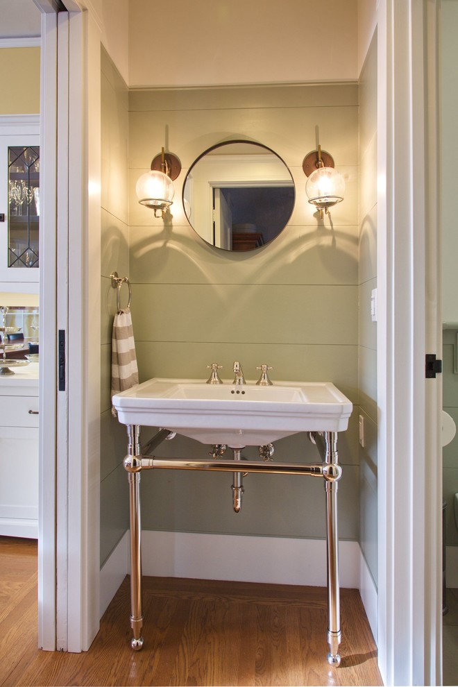 This is an example of a small arts and crafts 3/4 bathroom in San Francisco with an alcove shower, a two-piece toilet, white tile, ceramic tile, beige walls, medium hardwood floors, a console sink, brown floor and a hinged shower door.